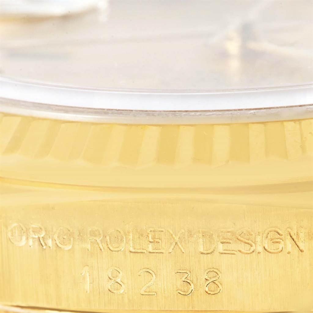 This image shows a close-up angle of the Rolex President 18238 Men's Yellow Gold Champagne Dial 18238 Men's Yellow Gold Champagne Dial model, focusing on the side engraving and part of the bezel and crystal.