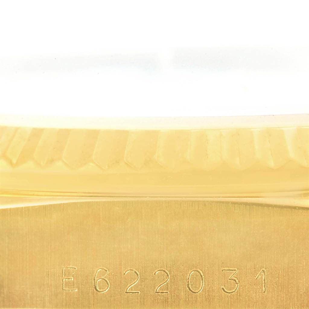 This image shows a close-up of the bezel and case side with the serial number of a Rolex President 18238 Men
s Yellow Gold Silver Dial 18238 Men
s Yellow Gold Silver Dial model.