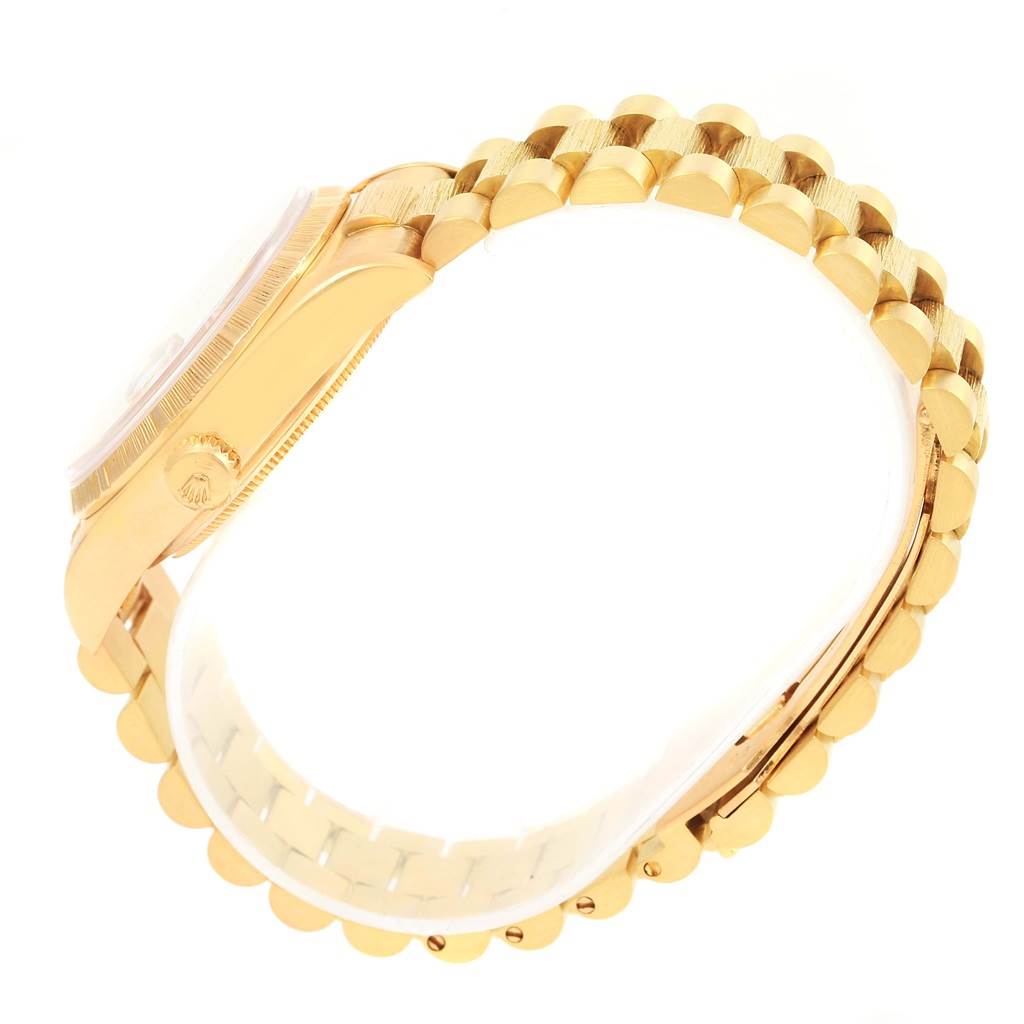 The image shows the side view of a Rolex President 18078 Men's Yellow Gold Champagne Dial 18078 Men's Yellow Gold Champagne Dial model watch, highlighting its gold case and signature bracelet.