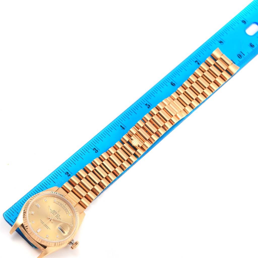 The image shows a top-down view of a Rolex President 18238 Men's Yellow Gold Champagne Dial 18238 Men's Yellow Gold Champagne Dial watch, including its face and full bracelet beside a blue ruler for scale.