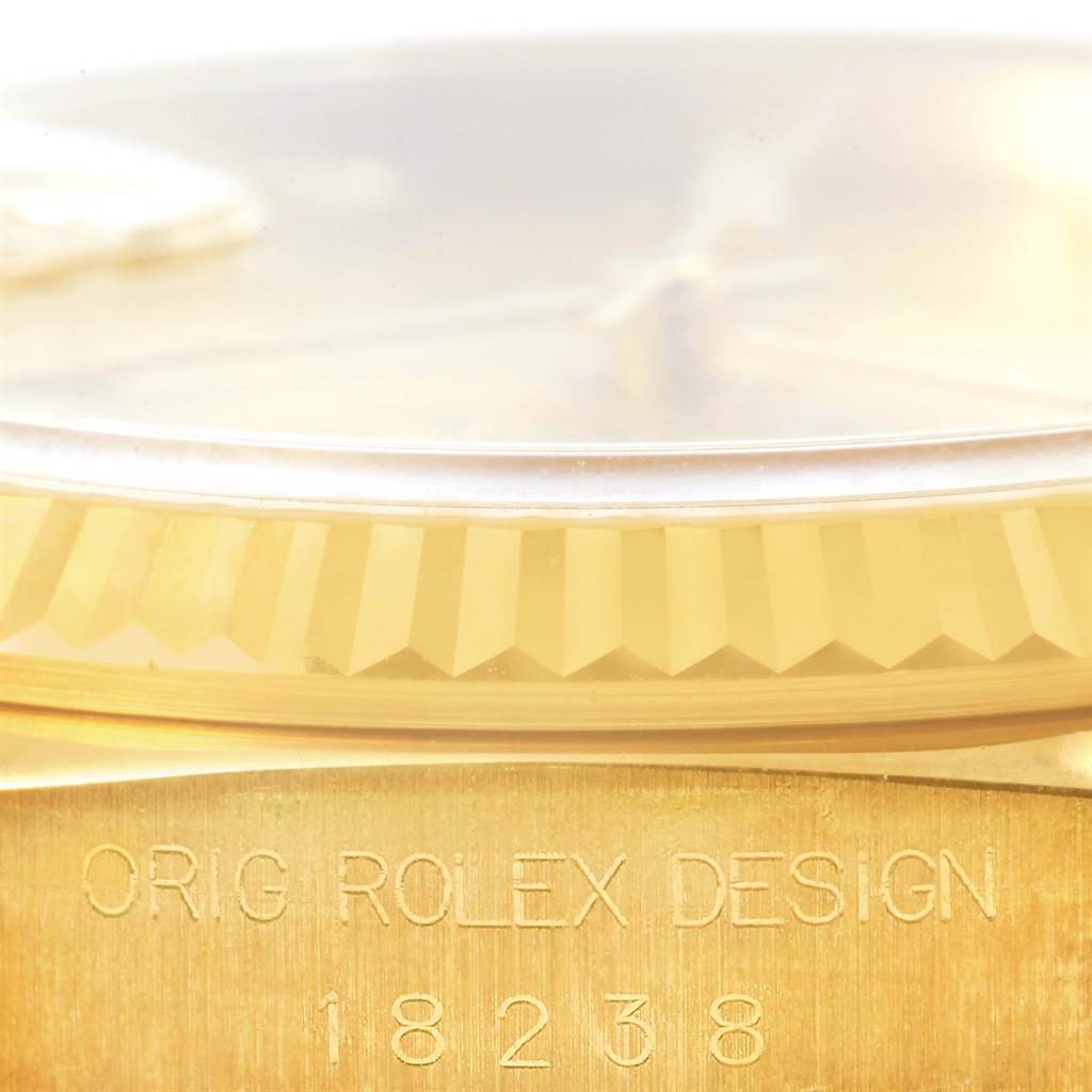This close-up image of the Rolex President 18238 Men's Yellow Gold Champagne Dial 18238 Men's Yellow Gold Champagne Dial model shows the side view, focusing on the crystal, bezel, and model number engraving.