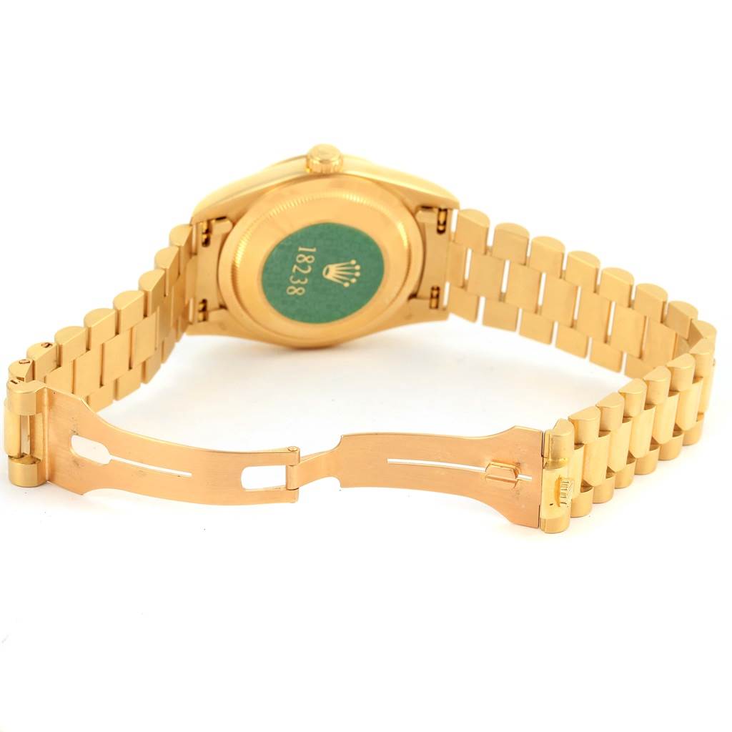The image shows the backside and clasp of a Rolex President 18238 Men's Yellow Gold Champagne Dial 18238 Men's Yellow Gold Champagne Dial model watch, highlighting the case back and partially open bracelet.