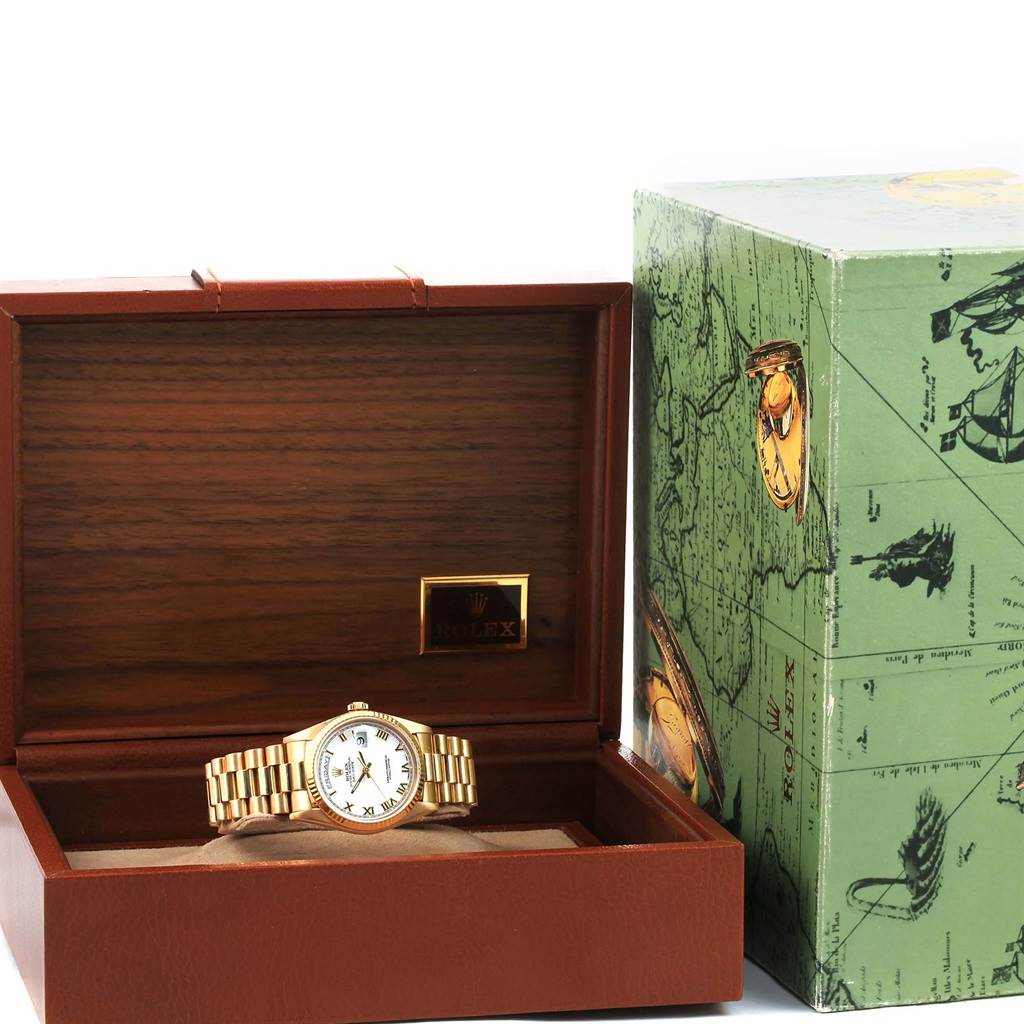 The image shows a Rolex President 18238 Men's Yellow Gold White Dial 18238 Men's Yellow Gold White Dial watch placed in an open wooden watch box, with the exterior packaging displayed beside it.