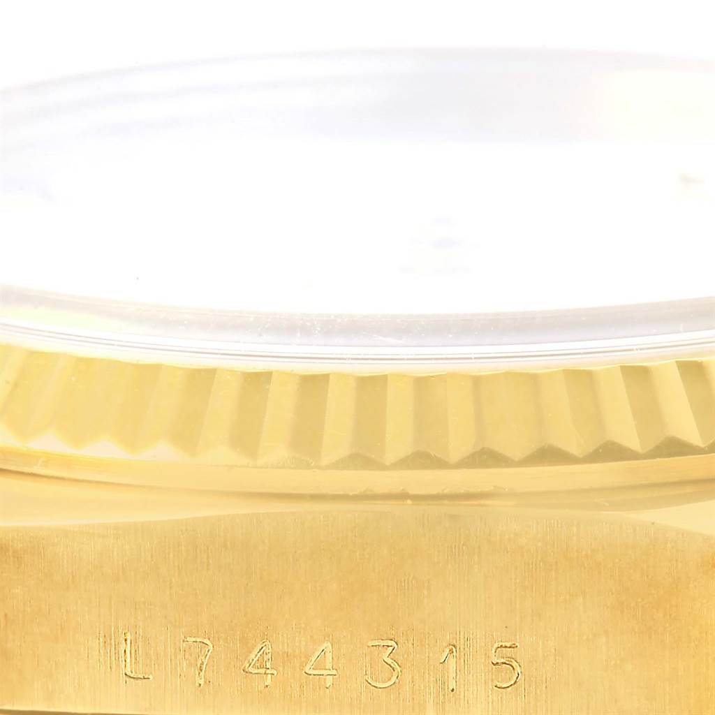 The image shows a close-up side view of the Rolex President 18238 Men's Yellow Gold White Dial 18238 Men's Yellow Gold White Dial model, focusing on its gold bezel and serial number.