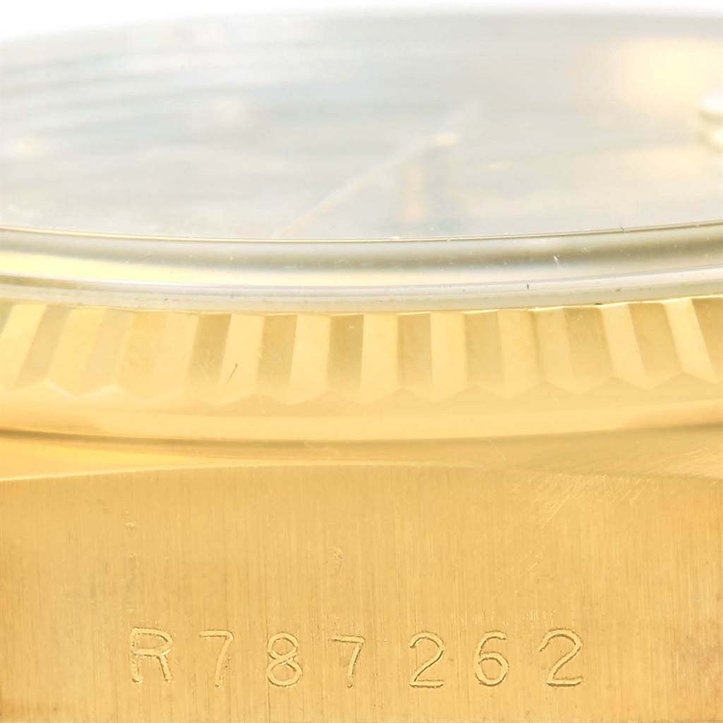 The image shows a close-up side angle of a Rolex President 18038 Men's Yellow Gold Champagne Dial 18038 Men's Yellow Gold Champagne Dial model watch, highlighting the serial number on the gold case and part of the fluted bezel.