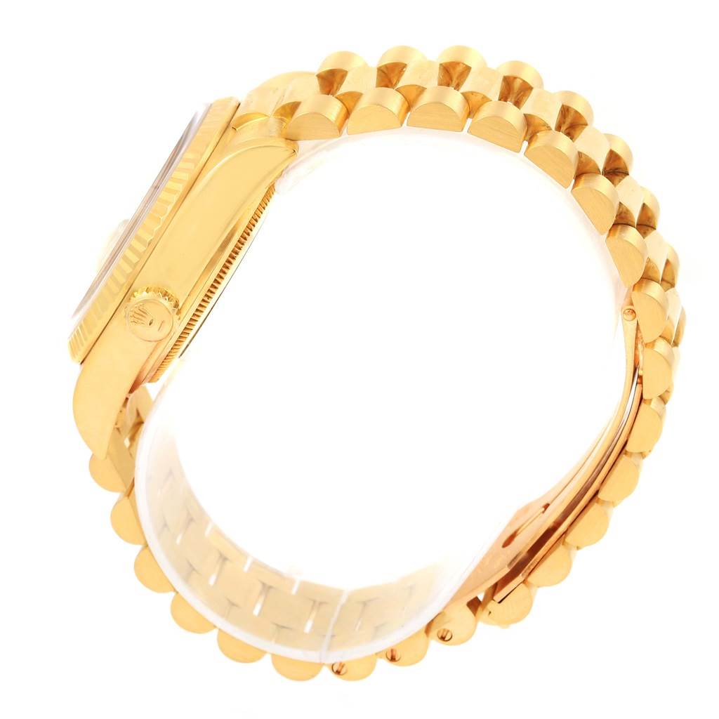 The image shows a side view of the Rolex President 18038 Men's Yellow Gold Champagne Dial 18038 Men's Yellow Gold Champagne Dial model watch, highlighting its crown, bezel, and a portion of its gold bracelet.