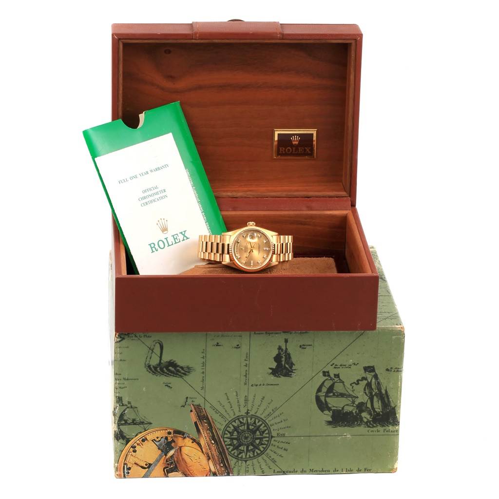 The Rolex President 18038 Men's Yellow Gold Champagne Dial 18038 Men's Yellow Gold Champagne Dial model is shown in an open box with a booklet standing next to the watch.