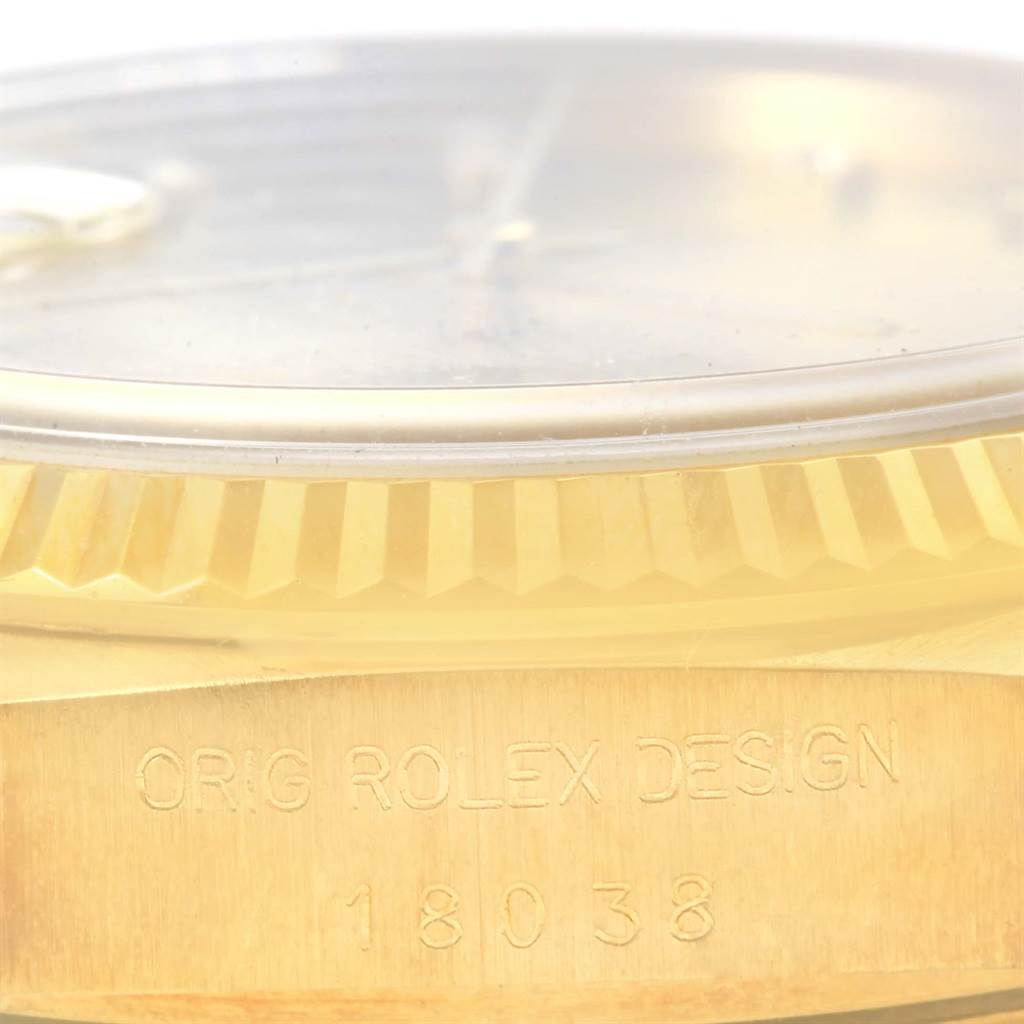 This close-up image shows the side of a Rolex President 18038 Men's Yellow Gold Champagne Dial 18038 Men's Yellow Gold Champagne Dial model, featuring "ORIG ROLEX DESIGN" and model number "18038" engraved.