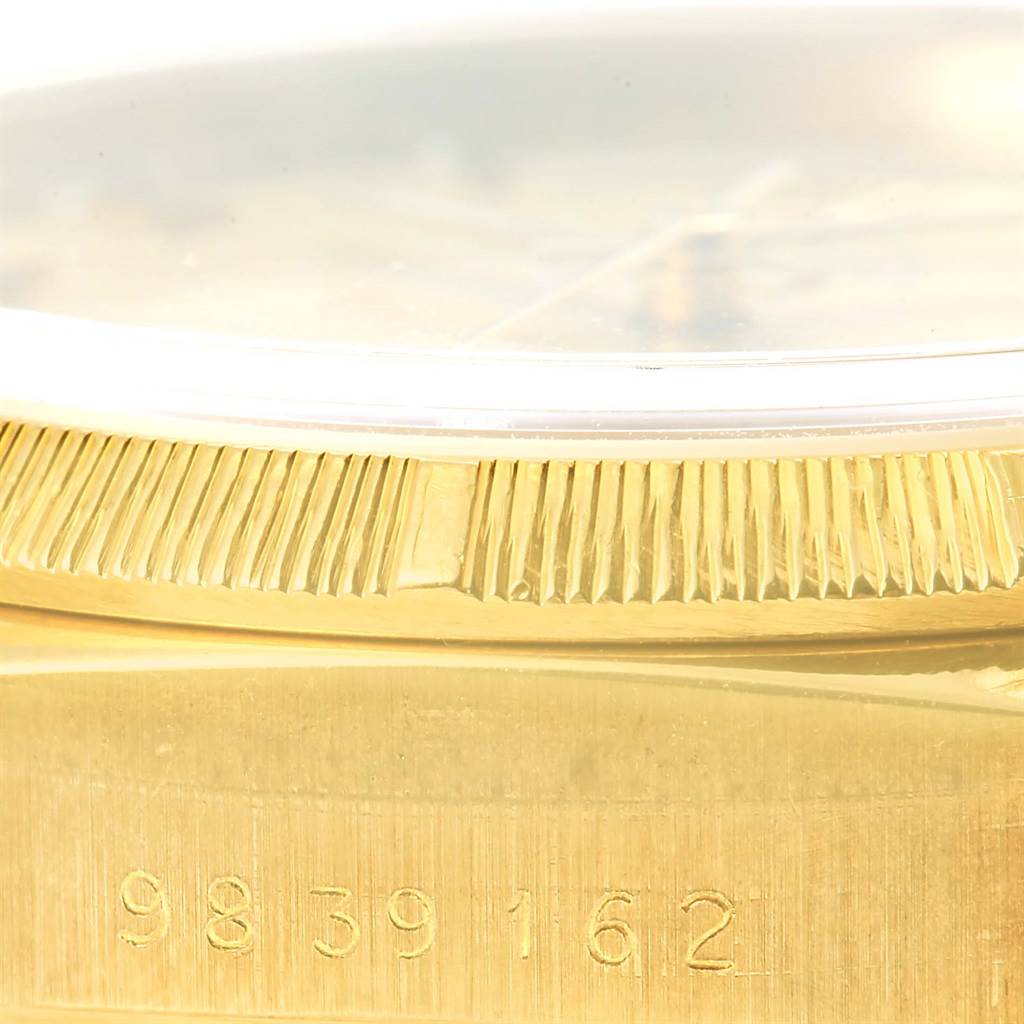 This close-up image shows the side of a Rolex President 18078 Men's Yellow Gold Champagne Dial 18078 Men's Yellow Gold Champagne Dial watch, highlighting the fluted bezel and part of the serial number.