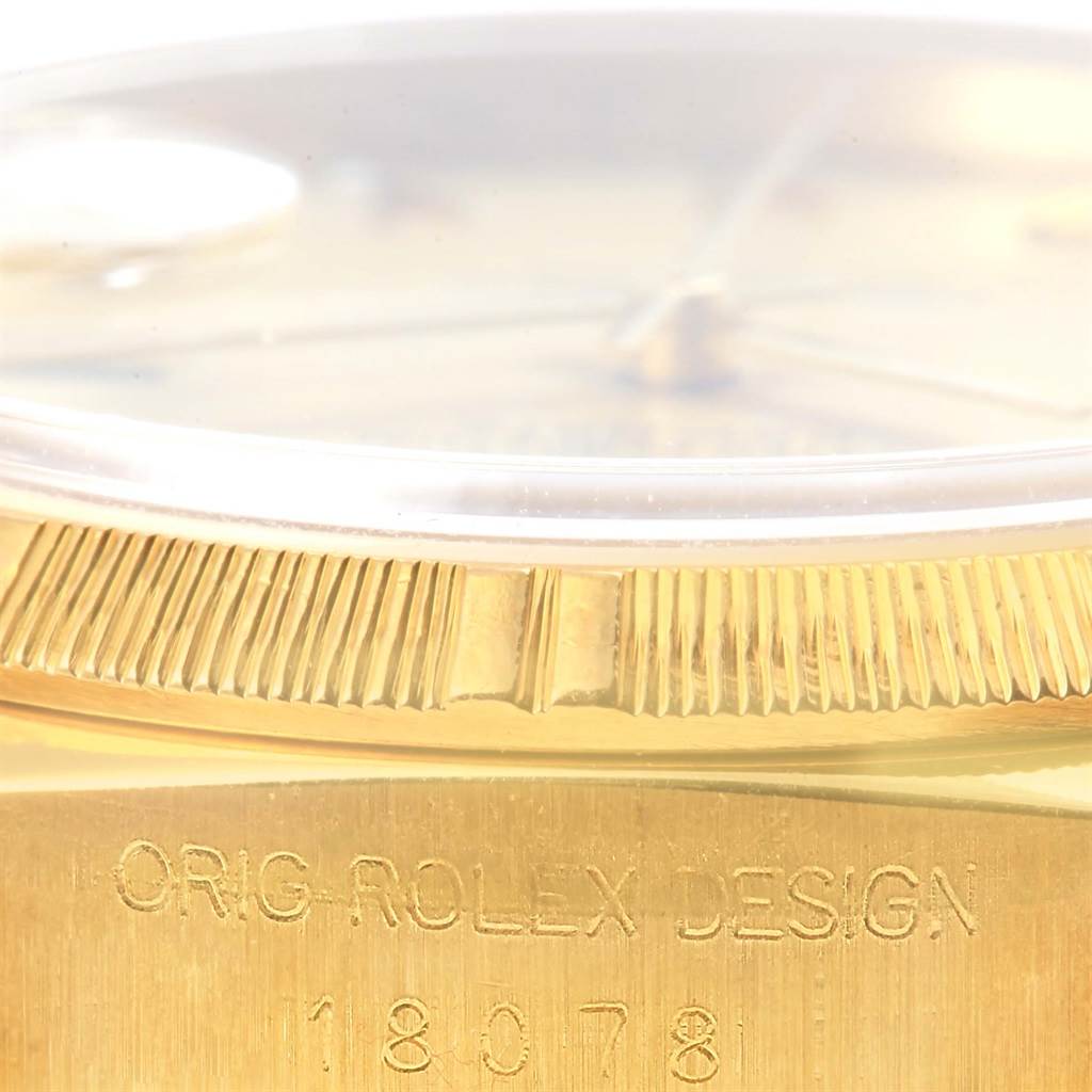 This image shows a close-up of the side of a Rolex President 18078 Men's Yellow Gold Champagne Dial 18078 Men's Yellow Gold Champagne Dial model watch, highlighting the bezel and engraved case number.