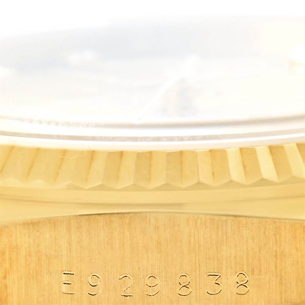 This image shows a close-up side view of the serial number and fluted bezel of a Rolex President 18238 Men's Yellow Gold Blue Dial 18238 Men's Yellow Gold Blue Dial model watch.