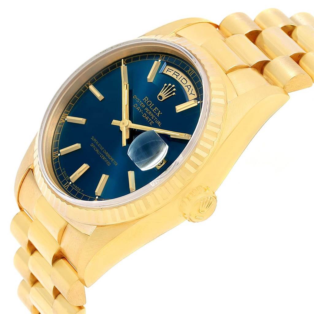 The image shows a Rolex President 18238 Men's Yellow Gold Blue Dial 18238 Men's Yellow Gold Blue Dial model watch with a gold band, blue dial, and magnified date, angled from the right side.