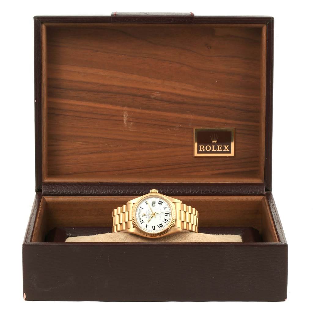 The image shows a Rolex President 1803 Men's Yellow Gold White Dial 1803 Men's Yellow Gold White Dial model watch placed straight on in a wooden Rolex box.