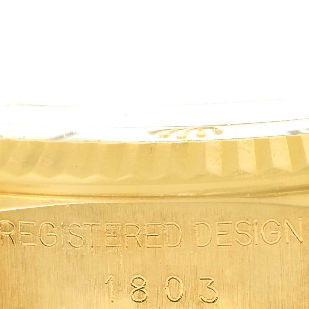 This is a close-up image showing the case back of a Rolex President 1803 Men's Yellow Gold White Dial 1803 Men's Yellow Gold White Dial model with "REGISTERED DESIGN 1803" engraved.