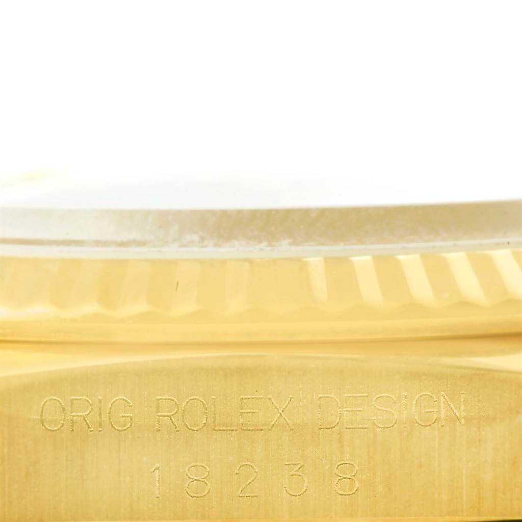 This image shows the side view and part of the case of the Rolex President 18238 Men's Yellow Gold White Dial 18238 Men's Yellow Gold White Dial model, showcasing the "Orig Rolex Design 18238" engraving.