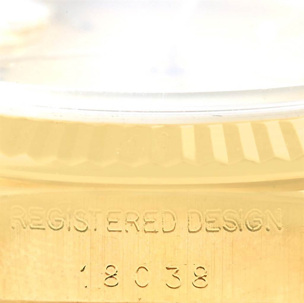 This image shows a close-up view of the case side of a Rolex President 18038 Men's Yellow Gold Champagne Dial 18038 Men's Yellow Gold Champagne Dial model, highlighting the fluted bezel and serial number.