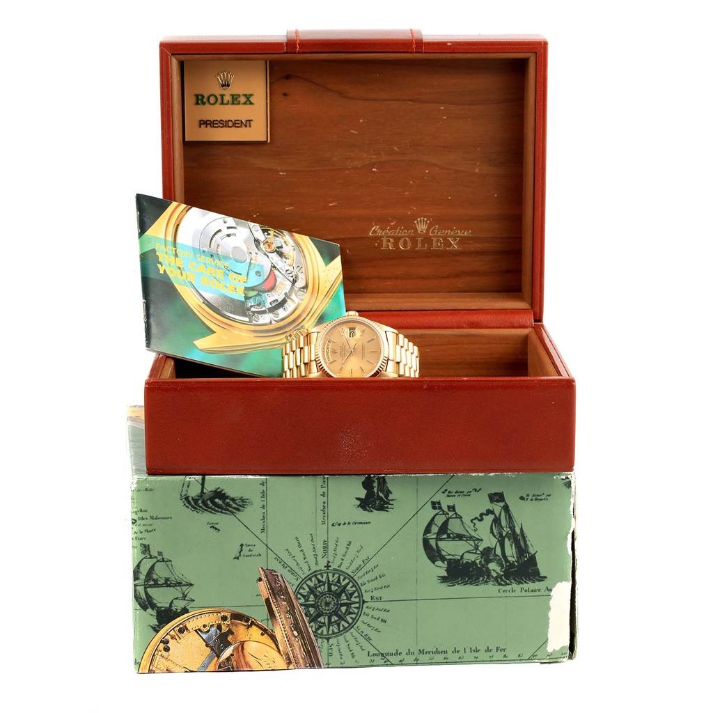 The image shows a Rolex President 18038 Men's Yellow Gold Champagne Dial 18038 Men's Yellow Gold Champagne Dial watch resting in an open box, accompanied by a booklet, viewed from the front angle.