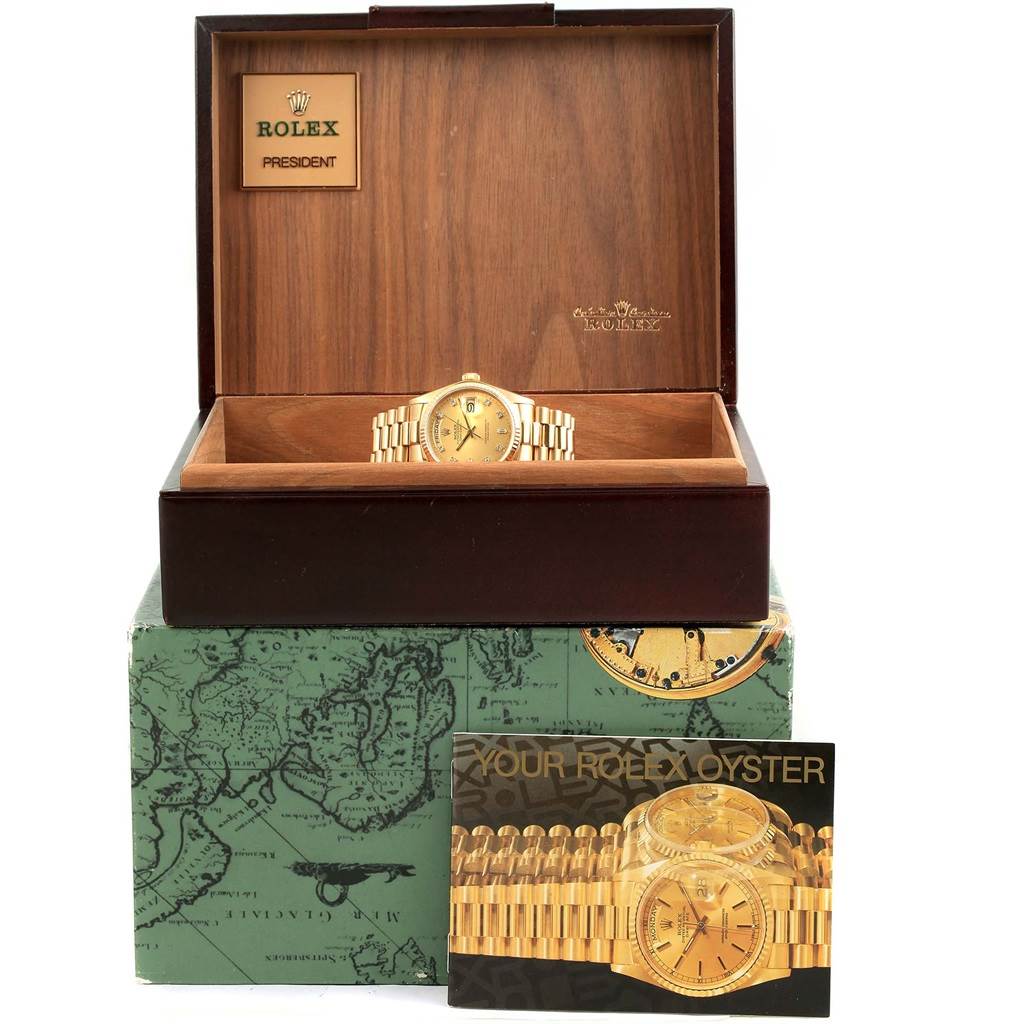The image shows a Rolex President 18038 Men's Yellow Gold Champagne Dial 18038 Men's Yellow Gold Champagne Dial model watch inside an open wooden display box, sitting atop a green-box and accompanied by a Rolex pamphlet.