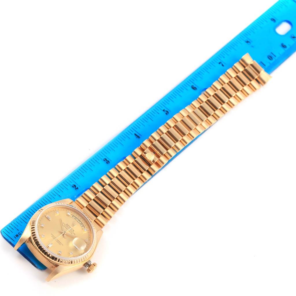 The image shows a Rolex President 18038 Men's Yellow Gold Champagne Dial 18038 Men's Yellow Gold Champagne Dial model watch laid flat next to a ruler, displaying the watch face and bracelet.