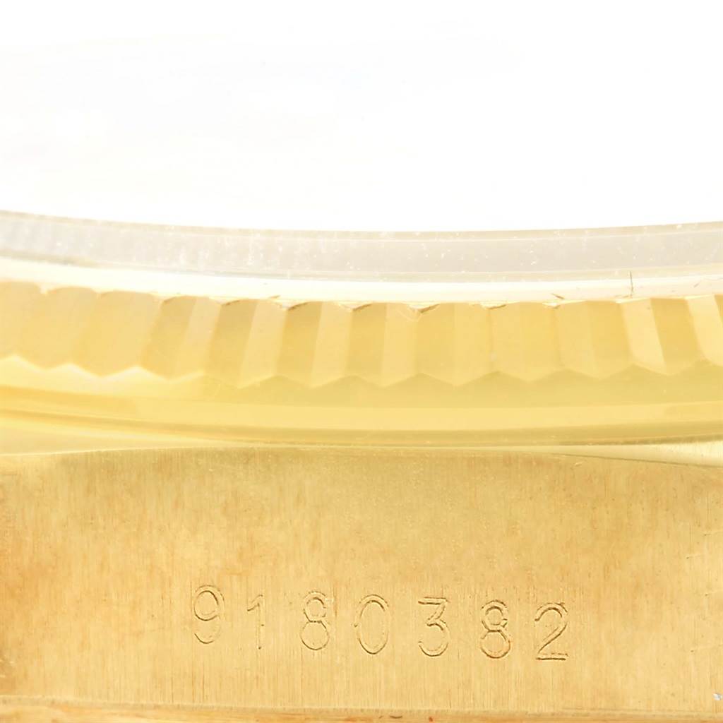 This image shows a close-up of the serial number and the fluted bezel of a Rolex President 18038 Men's Yellow Gold Champagne Dial 18038 Men's Yellow Gold Champagne Dial model.