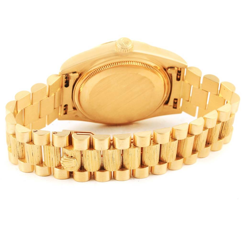 The image shows the back and bracelet of a Rolex President 18078 Men's Yellow Gold Blue Dial 18078 Men's Yellow Gold Blue Dial model watch at an angled view.