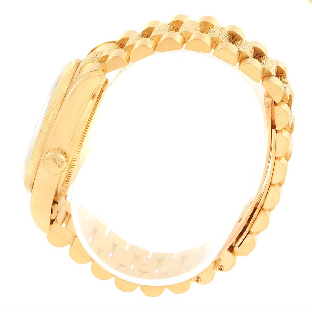 This image shows the side profile of a Rolex President 18078 Men's Yellow Gold Blue Dial 18078 Men's Yellow Gold Blue Dial model watch, focusing on its gold case, bezel, and bracelet.