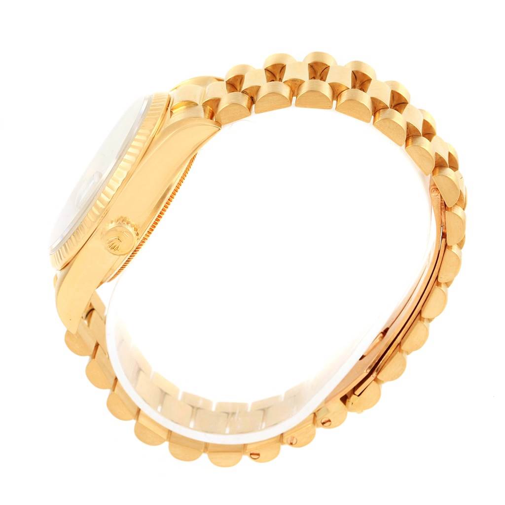 The image shows a side angle of the Rolex President 18038 Men
s Yellow Gold Beige Dial 18038 Men
s Yellow Gold Beige Dial watch, highlighting the gold case, crown, and part of the gold bracelet.