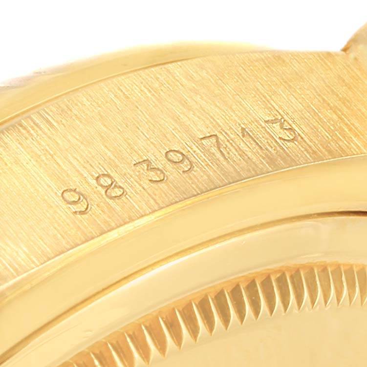 The image shows the serial number engraved on the side of the case and the fluted bezel of a Rolex President 18038 Men
s Yellow Gold Beige Dial 18038 Men
s Yellow Gold Beige Dial model watch.