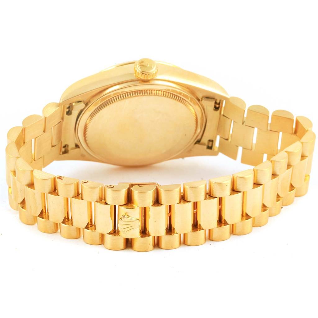The image shows the back view of a Rolex President 18038 Men
s Yellow Gold Beige Dial 18038 Men
s Yellow Gold Beige Dial model watch, highlighting its gold case back, crown, and bracelet.