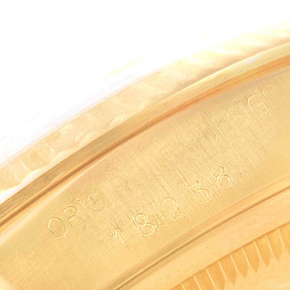 This close-up image shows the engraved inner rim of the bezel and case of a Rolex President 18238 Men's Yellow Gold Champagne Dial 18238 Men's Yellow Gold Champagne Dial model watch.