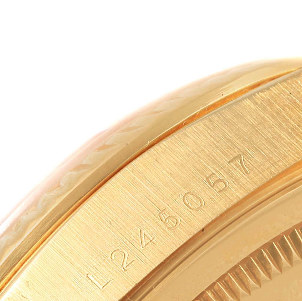 A close-up shot of the side of a Rolex President 18238 Men's Yellow Gold Champagne Dial 18238 Men's Yellow Gold Champagne Dial model watch, displaying the serial number engraving.