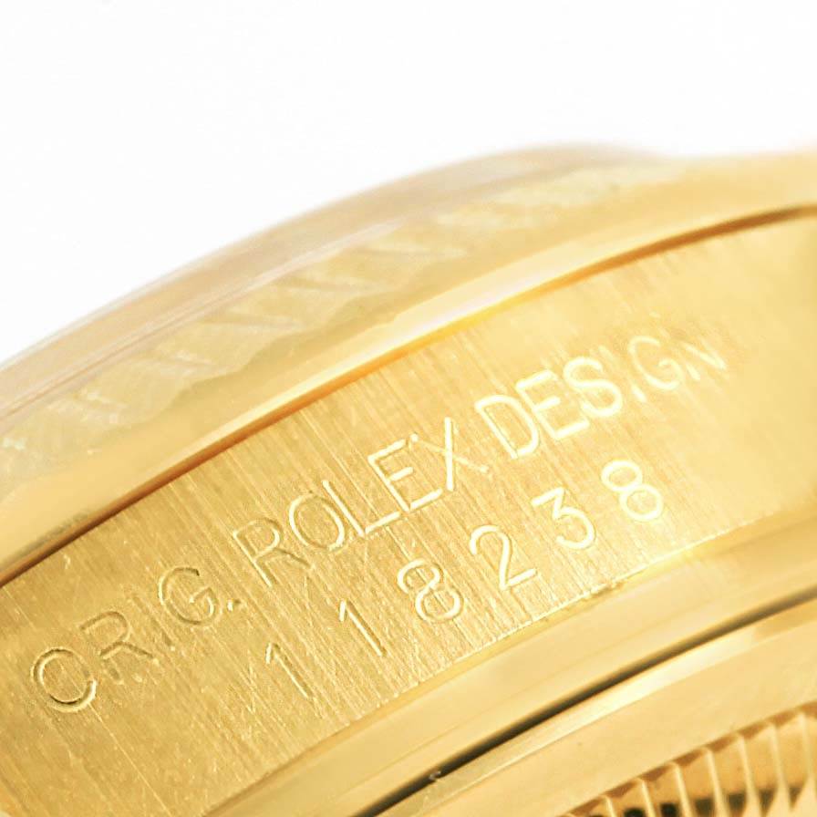 This is a close-up shot of the engraved side of a Rolex President 118238 Men's Yellow Gold Champagne Dial 118238 Men's Yellow Gold Champagne Dial model watch, focusing on the bezel and case edge.