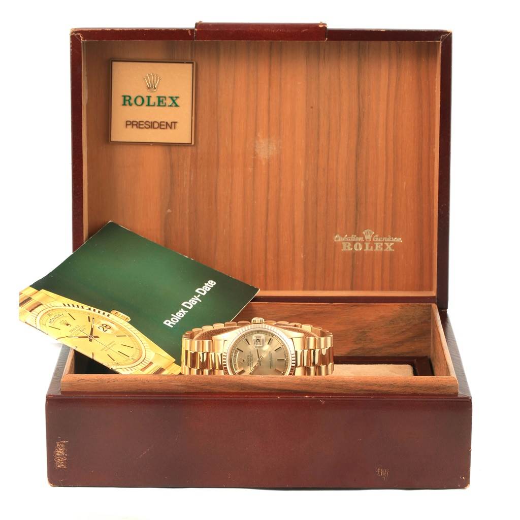 The image shows a Rolex President 18238 Men's Yellow Gold Champagne Dial 18238 Men's Yellow Gold Champagne Dial watch from the front, placed in an open wooden box with its booklet.