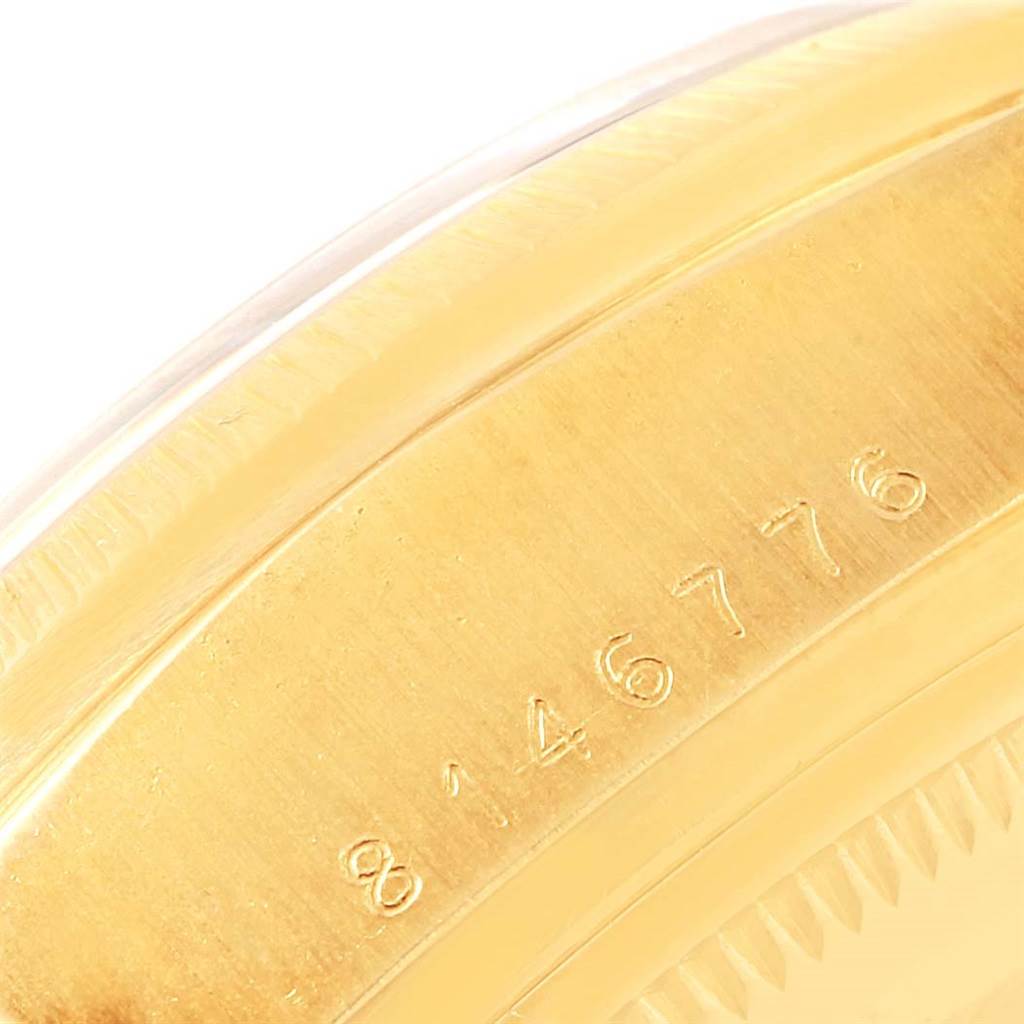 This close-up image shows the serial number engraved on the gold case of a Rolex President 18078 Men's Yellow Gold Black Dial 18078 Men's Yellow Gold Black Dial model watch.
