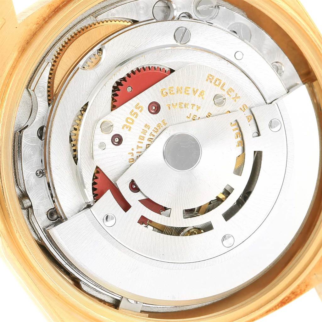 The image shows the internal mechanism of a Rolex President 18078 Men's Yellow Gold Black Dial 18078 Men's Yellow Gold Black Dial model watch, captured from the back, revealing cogs and rotor.