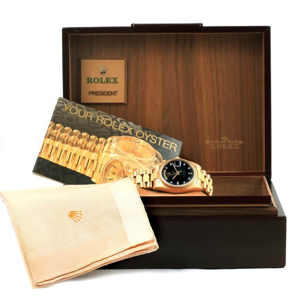 The image shows a Rolex President 18078 Men's Yellow Gold Black Dial 18078 Men's Yellow Gold Black Dial watch, its box, a cleaning cloth, and an instruction manual.