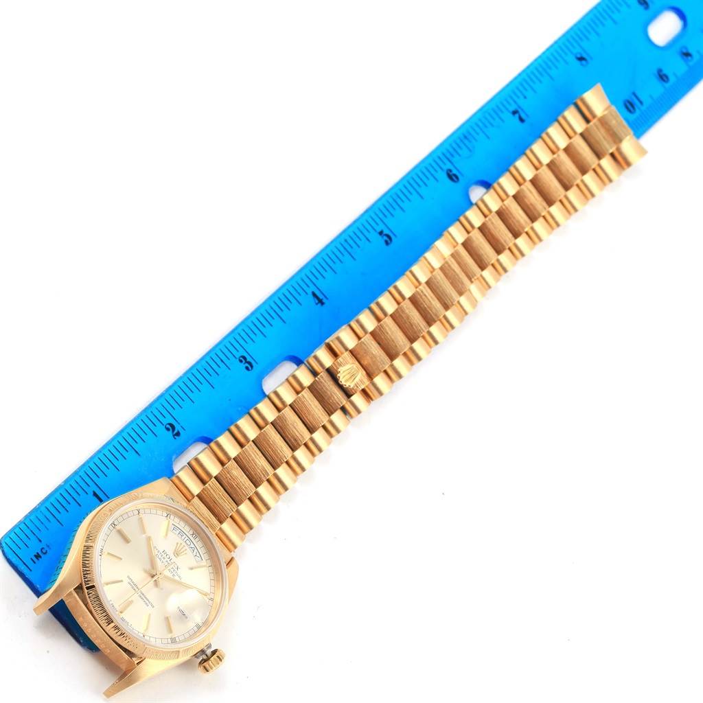 The image shows the Rolex President 18078 Men's Yellow Gold Silver Dial 18078 Men's Yellow Gold Silver Dial model watch laid flat next to a blue ruler, highlighting the face, crown, and bracelet.