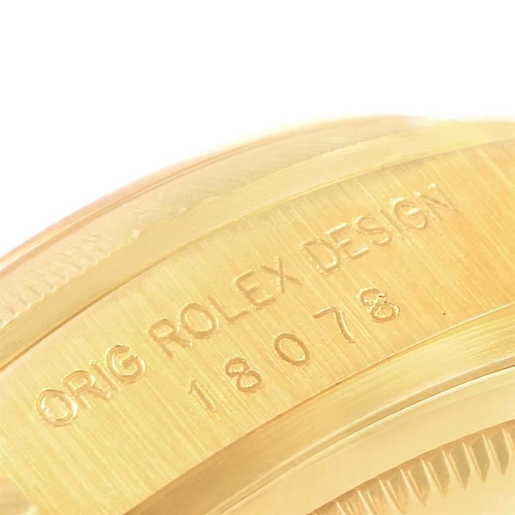 This image shows a close-up angle of the side of a Rolex President 18078 Men's Yellow Gold Silver Dial 18078 Men's Yellow Gold Silver Dial model, highlighting the engraving "ORIG ROLEX DESIGN 18078".