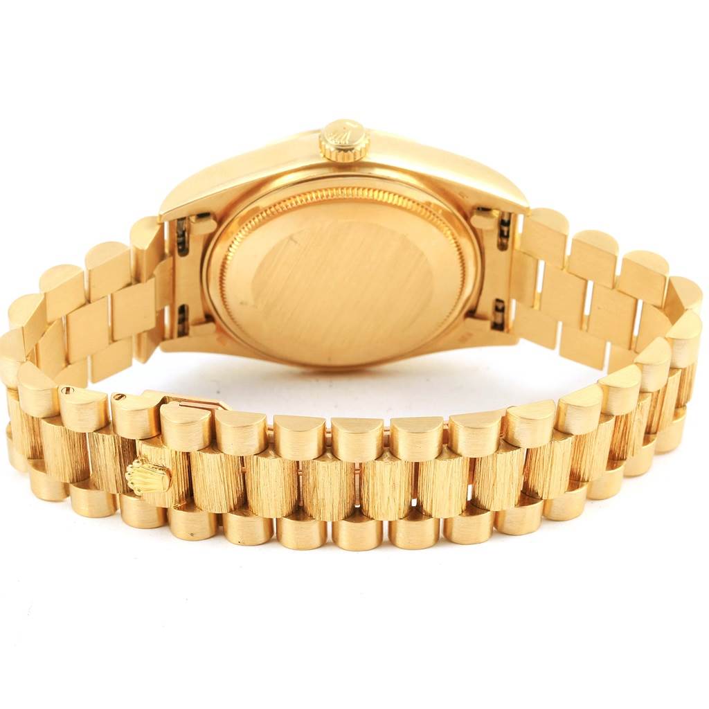 This image shows the gold caseback, crown, and bracelet of a Rolex President 18078 Men's Yellow Gold Silver Dial 18078 Men's Yellow Gold Silver Dial model watch from the rear.