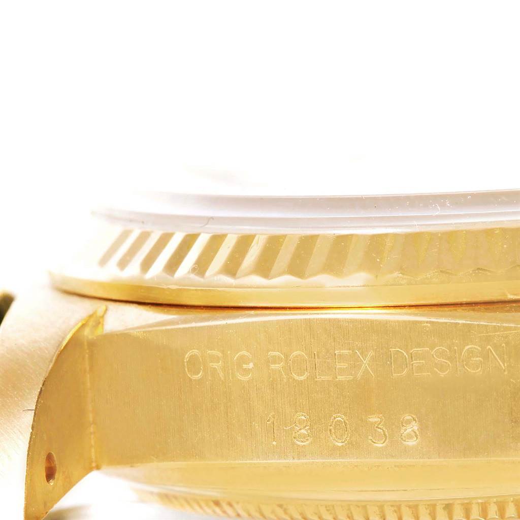 This close-up image shows the side view of the case and bezel of a Rolex President 18038 Men
s Yellow Gold Champagne Dial 18038 Men
s Yellow Gold Champagne Dial model, highlighting the "Orig Rolex Design" engraving.