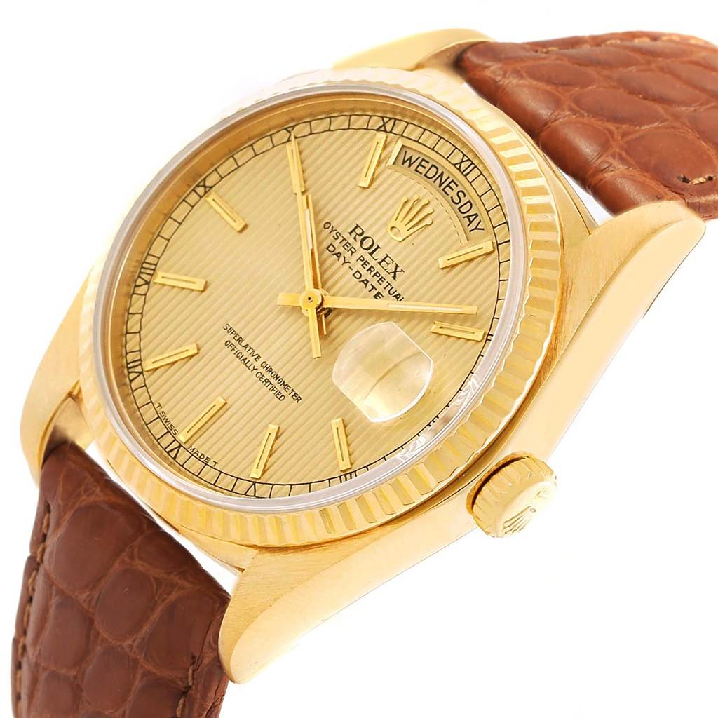 The Rolex President 18038 Men
s Yellow Gold Champagne Dial 18038 Men
s Yellow Gold Champagne Dial model watch is shown at an oblique angle, displaying its gold dial, fluted bezel, crown, and leather strap.