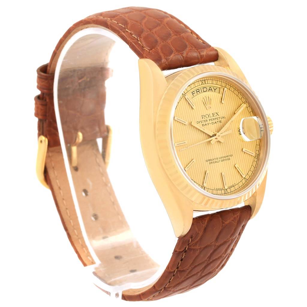 This Rolex President 18038 Men
s Yellow Gold Champagne Dial 18038 Men
s Yellow Gold Champagne Dial watch is shown at a slight angle, showcasing its face, dial, and brown leather strap.