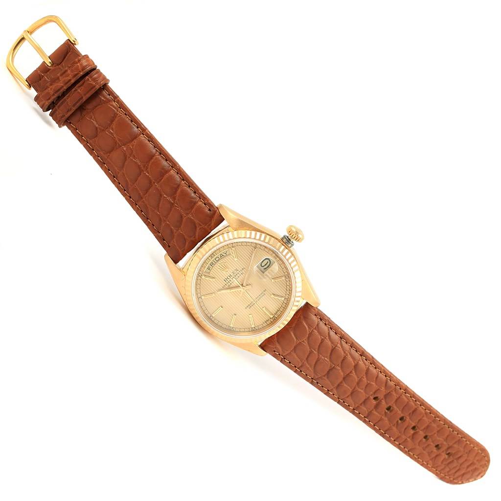 This image shows a Rolex President 18038 Men
s Yellow Gold Champagne Dial 18038 Men
s Yellow Gold Champagne Dial model watch at a slight diagonal angle, highlighting its dial, bezel, crown, and leather strap.