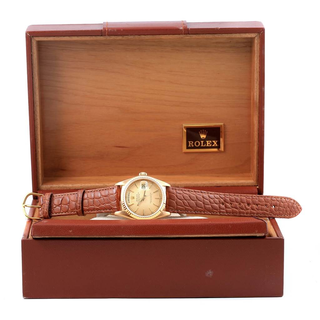 The Rolex President 18038 Men
s Yellow Gold Champagne Dial 18038 Men
s Yellow Gold Champagne Dial model watch is shown straight-on, displayed in an open wooden box.