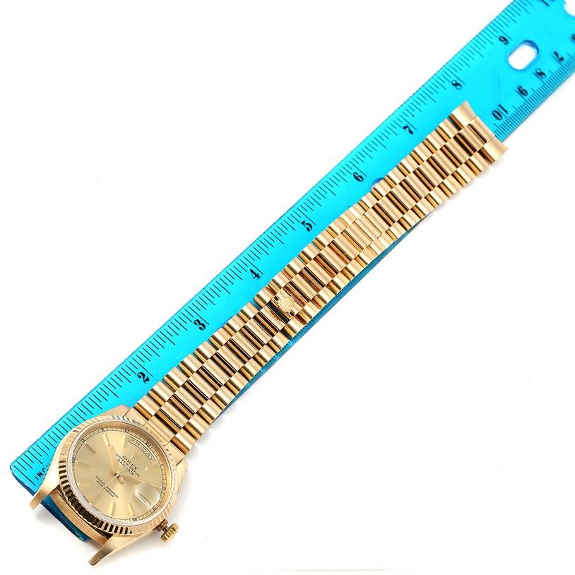 The image shows a Rolex President 18238 Men's Yellow Gold Champagne Dial 18238 Men's Yellow Gold Champagne Dial model watch from an overhead angle, with the bracelet next to a blue ruler for measurement.