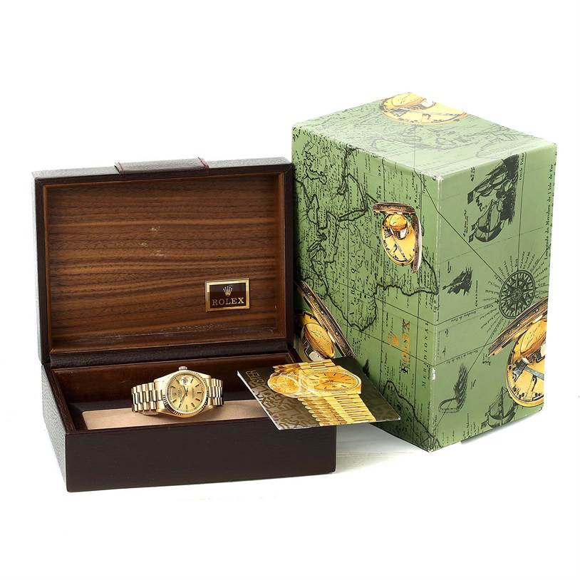 The Rolex President 18238 Men's Yellow Gold Champagne Dial 18238 Men's Yellow Gold Champagne Dial model watch is displayed front-view inside a wooden box, with the outer green box and booklets included.