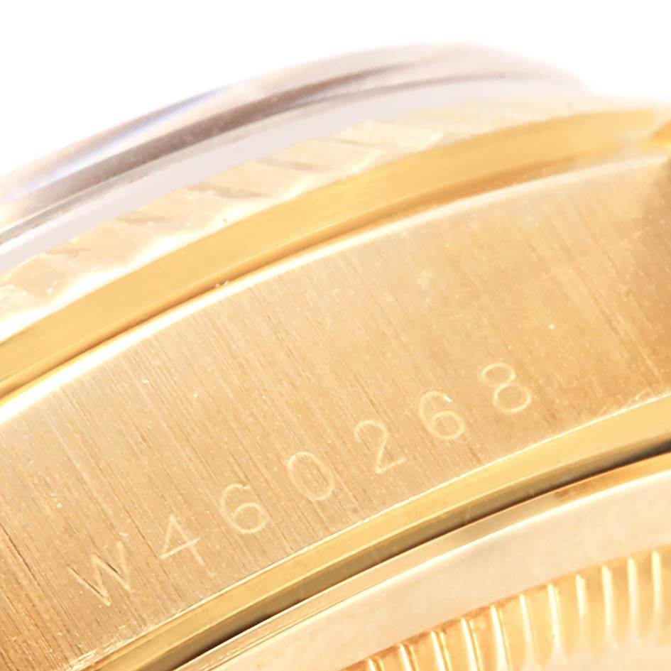 This close-up image shows the side of the Rolex President 18238 Men's Yellow Gold Brown Dial 18238 Men's Yellow Gold Brown Dial model watch, highlighting its serial number and part of the bezel.
