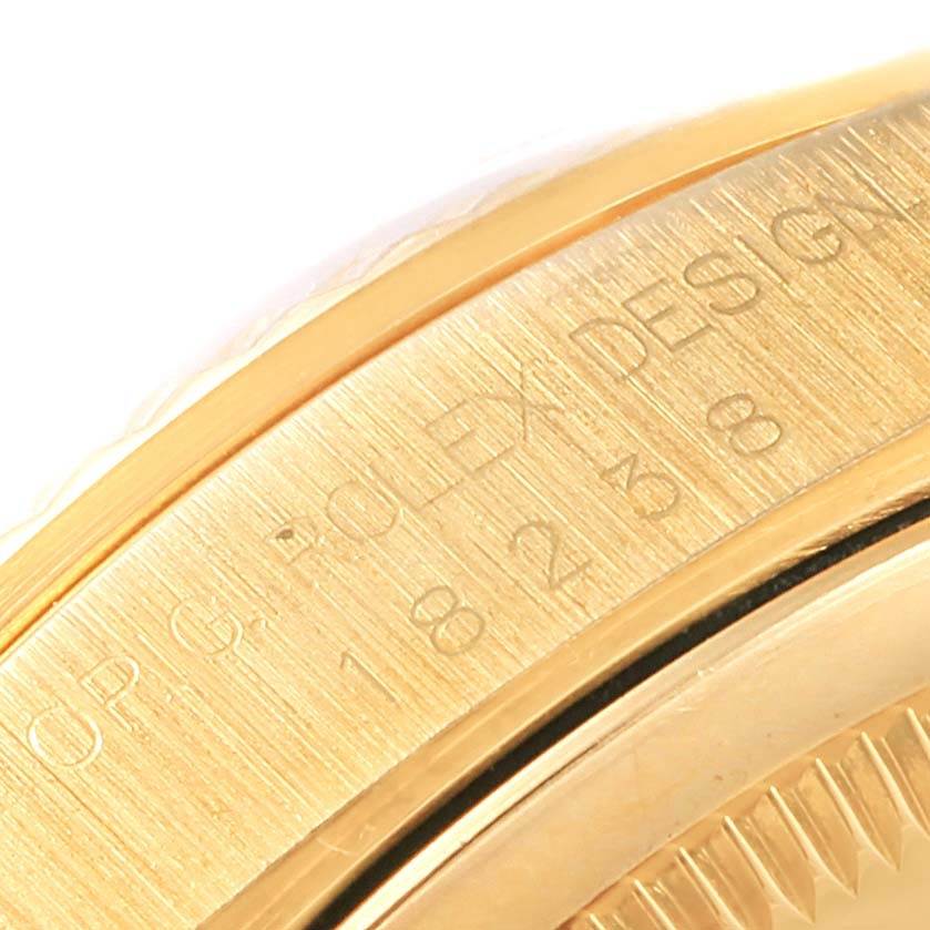 The image shows a close-up of the side of a Rolex President 18238 Men's Yellow Gold Brown Dial 18238 Men's Yellow Gold Brown Dial model, highlighting the engraved lettering on the case.