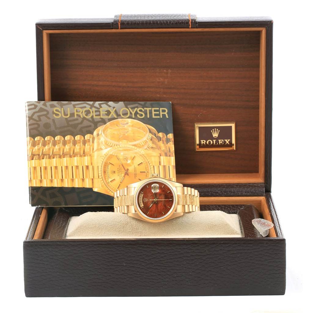 The image shows a Rolex President 18078 Men's Yellow Gold Brown Dial 18078 Men's Yellow Gold Brown Dial model watch positioned inside its open display box with accompanying booklet.