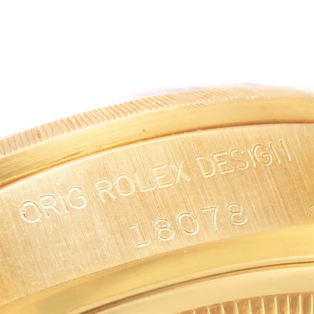 This is a close-up of the side of a Rolex President 18078 Men's Yellow Gold Brown Dial 18078 Men's Yellow Gold Brown Dial model watch, showing the engraved design and model number.